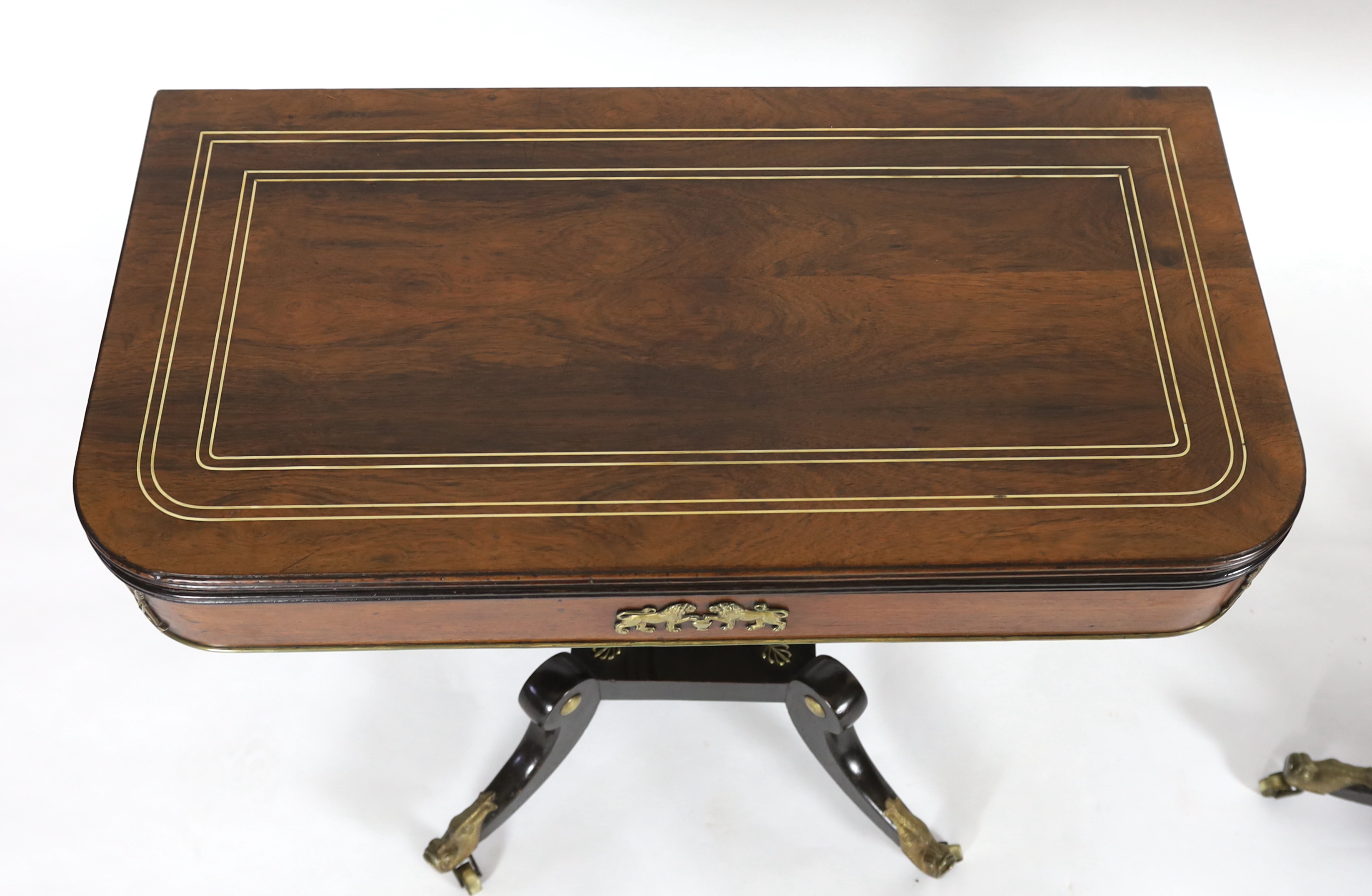 A pair of Regency brass inset rosewood and ebonised card tables 91cm wide, 45cm deep, 75cm high